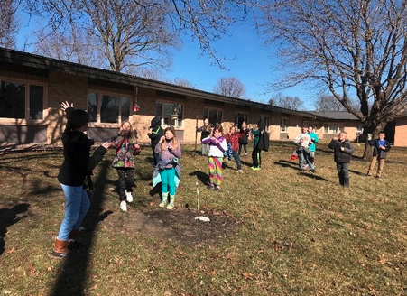 elementary kids playing outside with bubbles